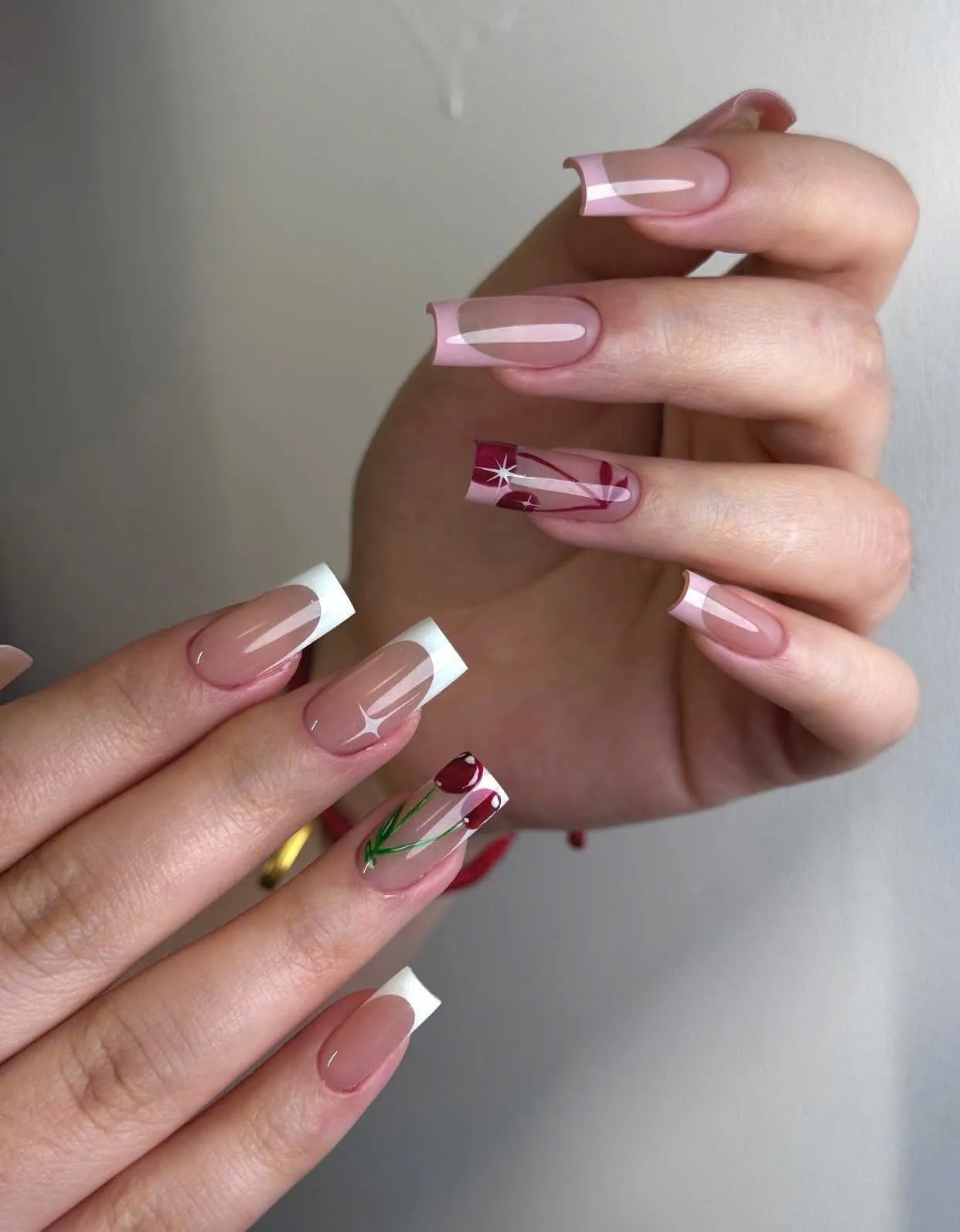 White French tip nails with hand-painted cherry and star detail