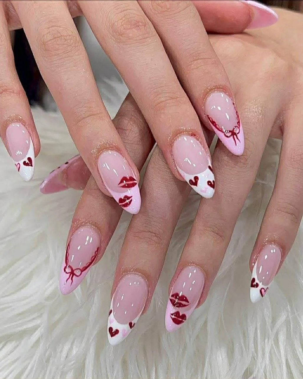 Almond French nails with red hearts, lips and bow Valentine art