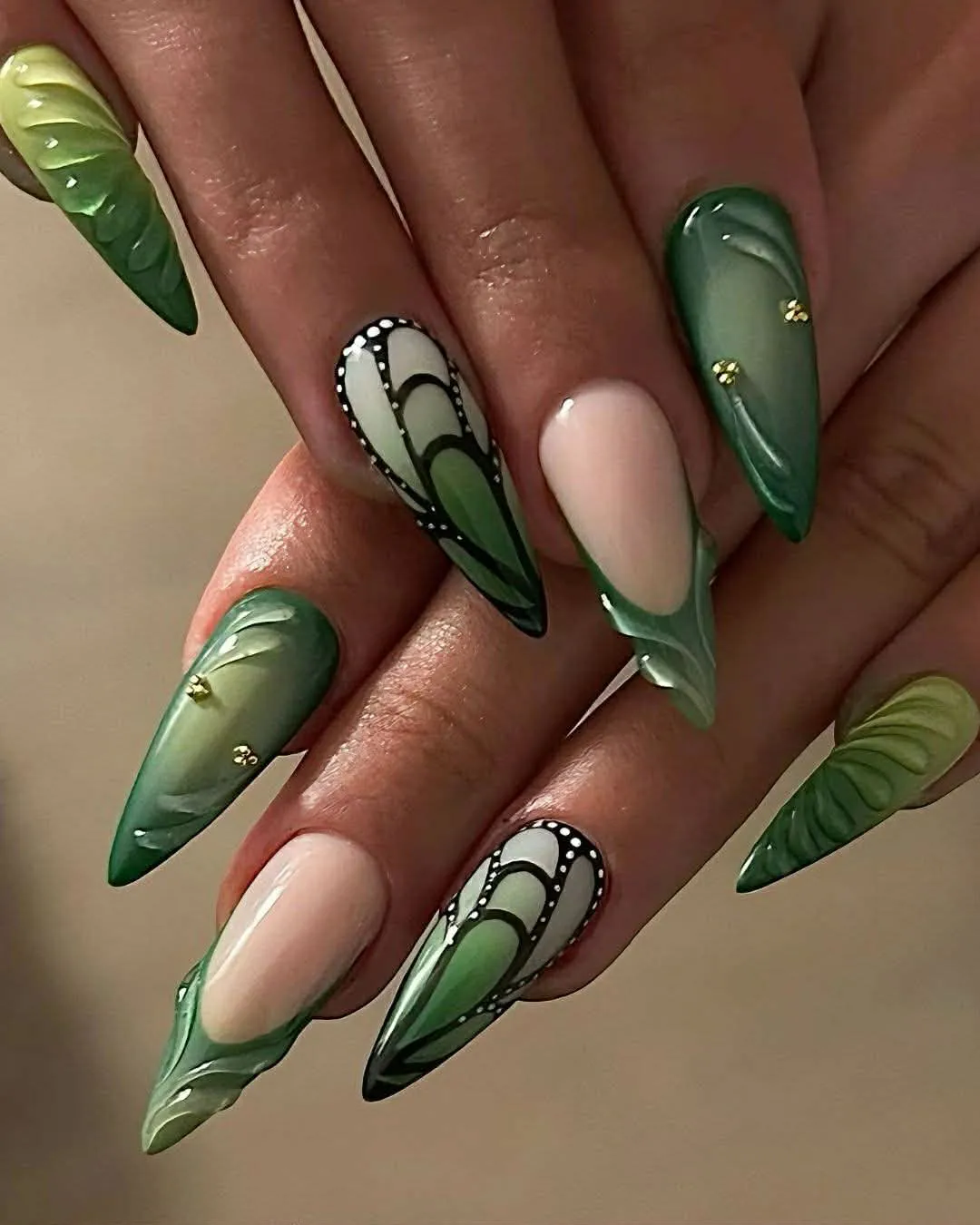 Green ombre stiletto nails with butterfly wing art and 3D detail