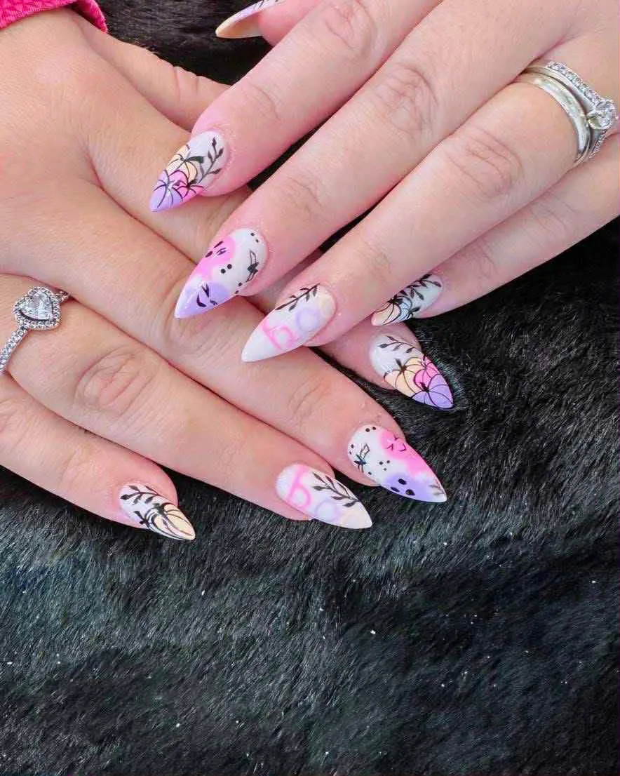 Stiletto nails with pastel airbrush and fine black floral linework