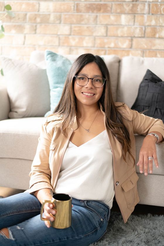 Trish Guerrero relaxing with a cup of coffee, representing the calm, grounded approach of Mending Minds Counseling.