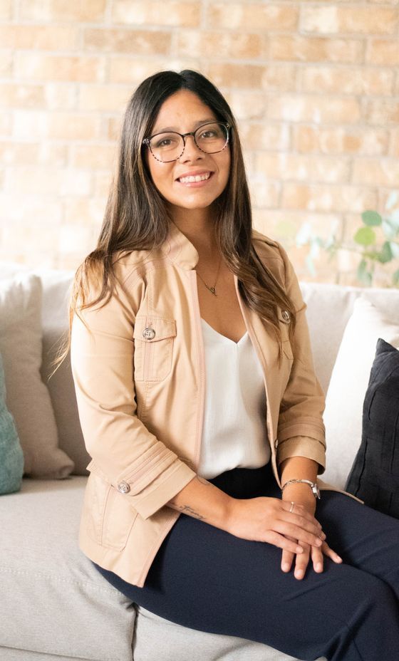 Trish Guerrero seated on a couch, representing the grounded, collaborative approach used at Mending Minds Counseling.